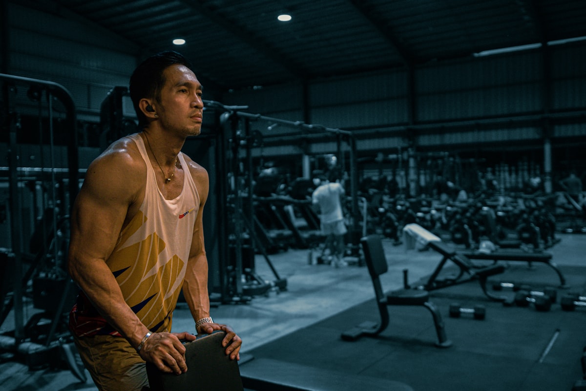 Male athlete stretching and recovering after workout